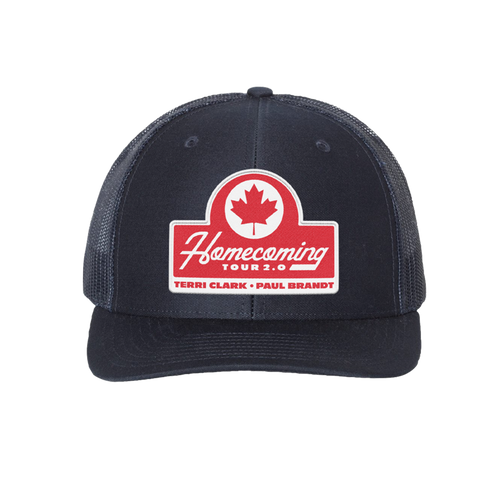 A navy trucker-style baseball cap with a red and white 'Homecoming Tour 2.0' patch on the front, featuring a red maple leaf logo. The cap has navy mesh side panels and a navy curved brim, shown against a plain white background.
