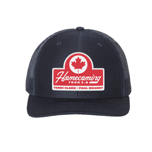 A navy trucker-style baseball cap with a red and white 'Homecoming Tour 2.0' patch on the front, featuring a red maple leaf logo. The cap has navy mesh side panels and a navy curved brim, shown against a plain white background.